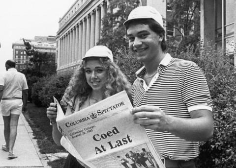 Photo of students holding Spec's "Coed At Last" issue from August 1983
