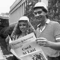 Photo of students holding Spec's "Coed At Last" issue from August 1983