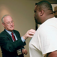 Dr. Archie Roberts ’65 (left) talks with former Miami Dolphins football player Keith Sims at the Living Heart NFL Players CV Health Program in January in Miami