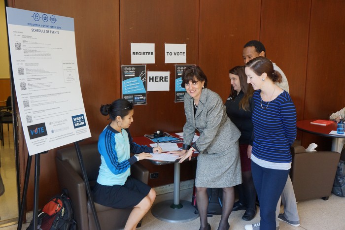 Ester Fuchs, professor of international and public affairs at SIPA, directs a group of SIPA students at one of the three voter registration tables set up by Voting Week organizers. Photo: Kevin Gully