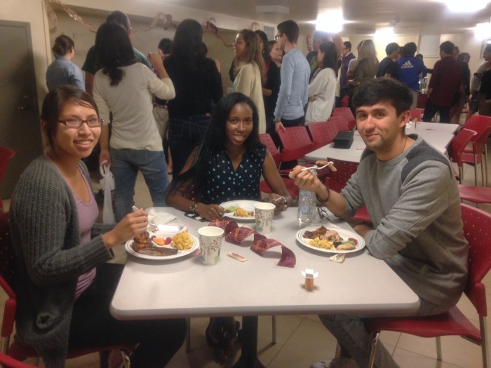 SIC House residents at the house's weekly dinner. Photo: Student members of Creative Commons prepare music for an event. Photo: Angel Wang CC’16