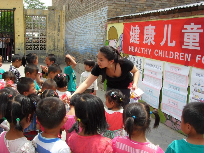 Sida Li CC '15 hands out small gifts after a health lesson. PHOTO: Courtesy Sida Li