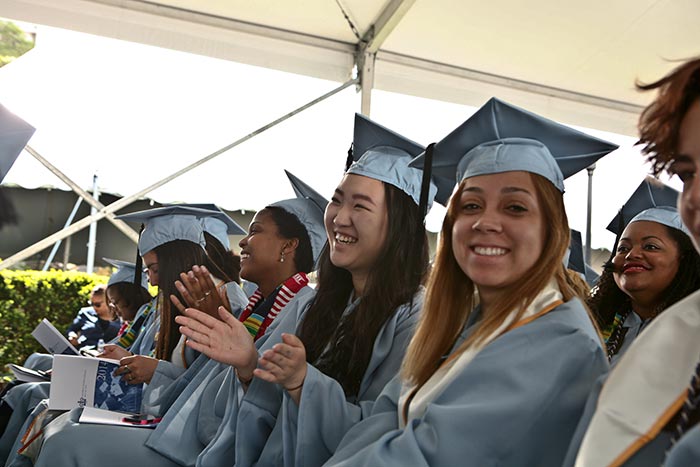 Students sitting and cheering.