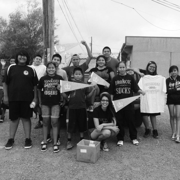 Fantasia Painter CC’13 (center, bottom row), Christian White CC'15 (center, back row) and Tristin Moone CC'15 (center, holding flag) in To'hajiilee with students during the summer of 2013. Photo: John Gamber, AlterNATIVE academic adviser