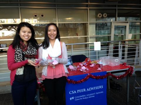 Peer Advisers Jiawen Tang ’15 and Jennifer Bai ’13  handed out treats in Lerner as part of a CSA Cares event during Wellness Week in 2013. Photo: Courtesy of Columbia Student Affairs.