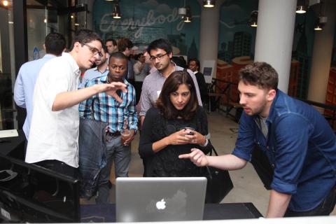 Columbia officials, including President Lee C. Bollinger and Dean James J. Valentini, joined with government officials on June 15 for an official ribbon-cutting ceremony at the opening of the Columbia Startup Lab in lower Manhattan. The facility, located on the ground floor of WeWork Soho West in NYC’s Silicon Alley, provides a co-working space with heavily subsidized rent for alumni who have graduated within the past five years and have started their own businesses. Matt Star ’12 (left, in white shirt) sho