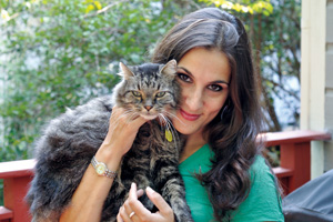 Maya Gupta ’99, shown here with her cat Biskie, fostered kittens in her off-campus apartment during her senior year at the College. PHOTO: George Carless