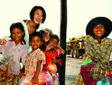 Nettra Pan ’12, posing here with child vendors in Cambodia, encourages fellow students to undertake service projects in Southeast Asia. PHOTO: Andy Fletcher
