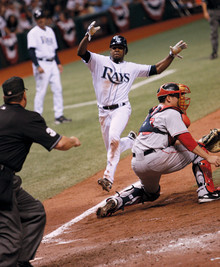 Above, Perez slides home with the winning run after tagging up on a short pop fly to right field as the Rays beat the Boston Red Sox 9–8 in 11 innings in Game 2 of the 2008 American League Championship Series. Photo: Tampa Bay Rays – Steven Kovich