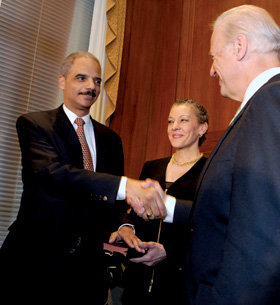 Holder shakes hands with Vice President Joe Biden on February 3 after being sworn in as attorney general. PHOTO: COURTESY OF THE DEPARTMENT OF JUSTICE