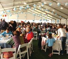 Everyone flocks to the gourmet picnic under the Big Tent to eat, meet and mingle. 