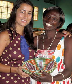 The president of a local women’s cooperative in the Muhanga district presents Neda Navab ’08 with a handmade basket as a token of thanks at the training program graduation ceremony. 