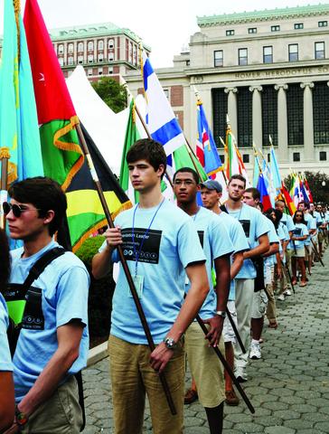 Orientation leaders march with flags from every state and country represented in the student body, part of the pageantry of Convocation.
