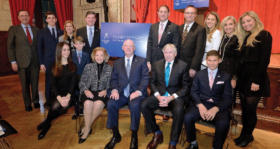 A group of people in dresses and suits