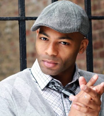 A young man in a flat grey cap