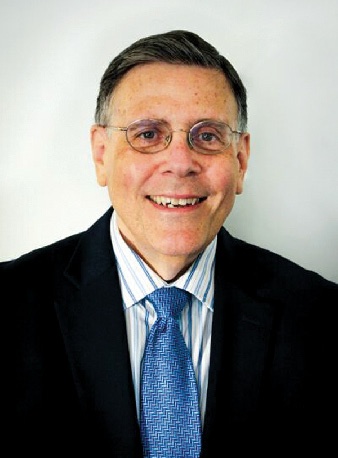 A man in a blue tie, looking at the camera