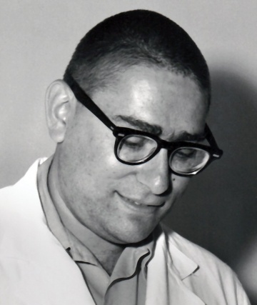 a man in glasses looking downward