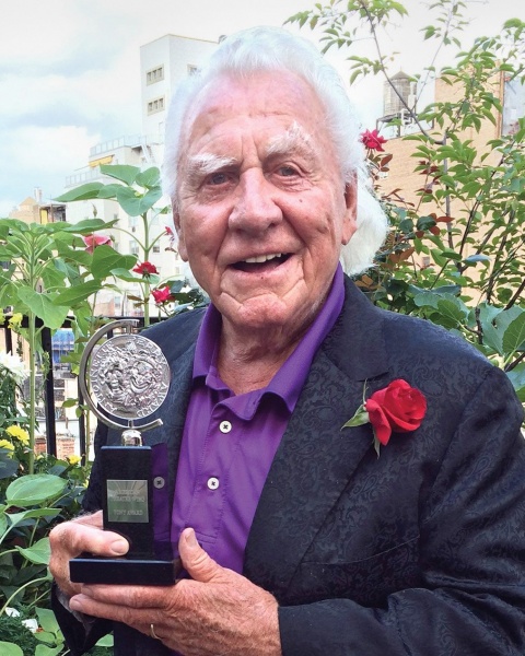 a man holding an award