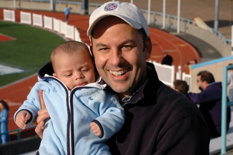 Michael Behringer ’89 poses with a baby.