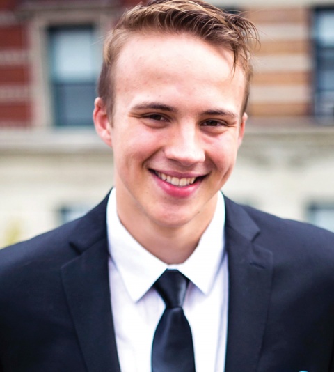 A young white man in a suit and tie