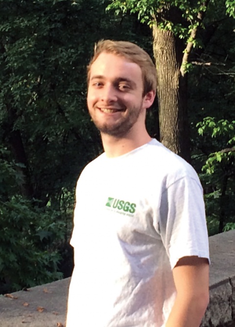 A young white man in a white t-shirt