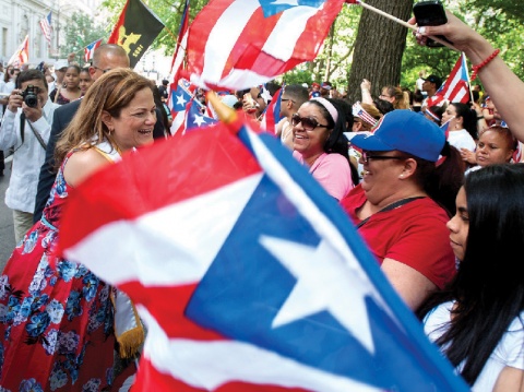 A blurry Puerto Rican flag and happy people