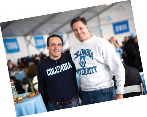 Two men wearing Columbia sweatshirts, smiling at the camera