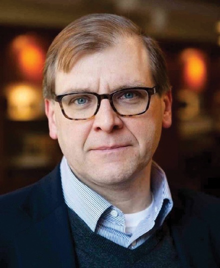 A man wearing glasses and looking at the camera