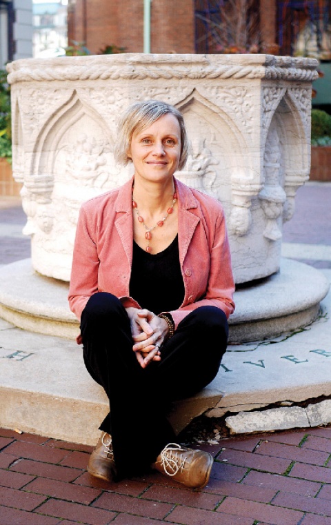 A white woman in a pink jacket