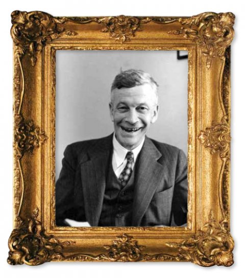 A smiling man in a suite and tie in a black and white photograph