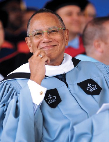 A man wearing Columbia academic regalia and smiling