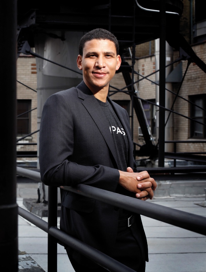 Robert Reffkin ’00, BUS’03 poses on the balcony of an apartment complex.