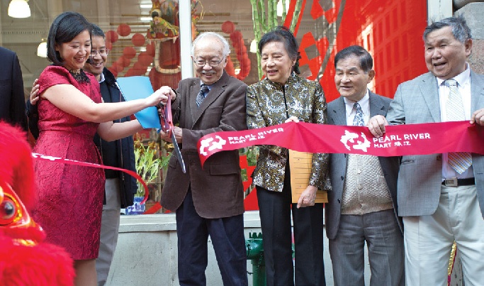 Joanne Kwong ’97 and her in-laws cut the ribbon at Pearl River Mart's reopening.