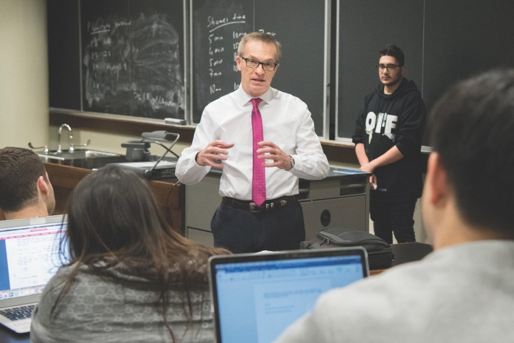 a man in a red tie in a classroom