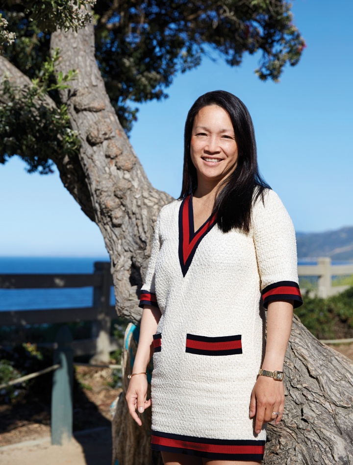 a woman standing in front of a tree