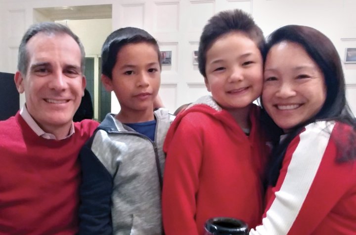 a white man and an Asian woman flanking two Asian boys