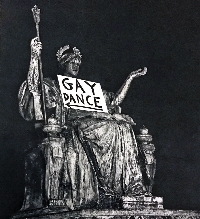 A sign labeled "Gay Dance" rests on the lap of the Alma Mater statue on Columbia's campus.