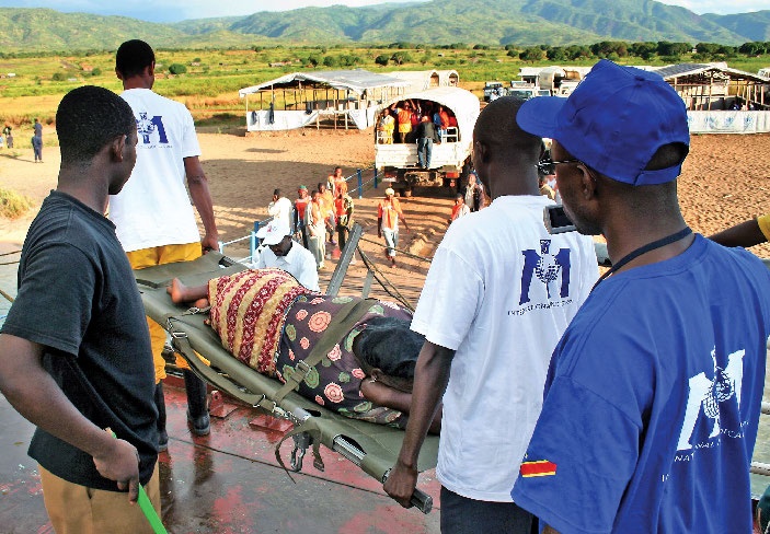 IMC staff carrying a stretcher