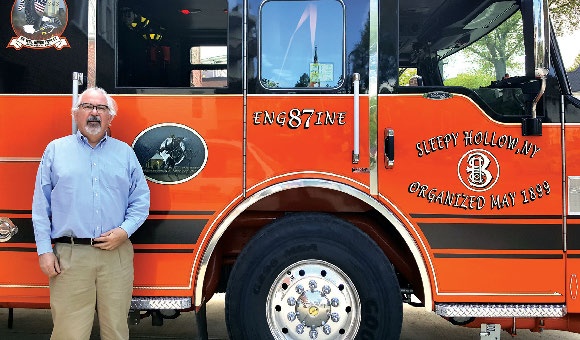 man in front of a fire truck