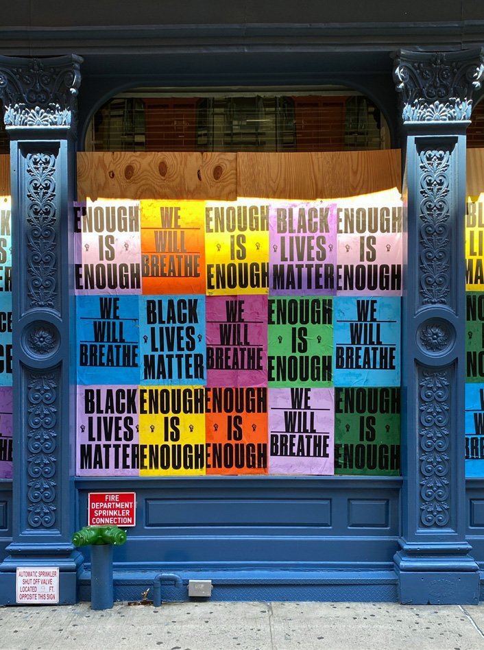 Posters with the words 'Black Lives Matter' on a boarded-up building