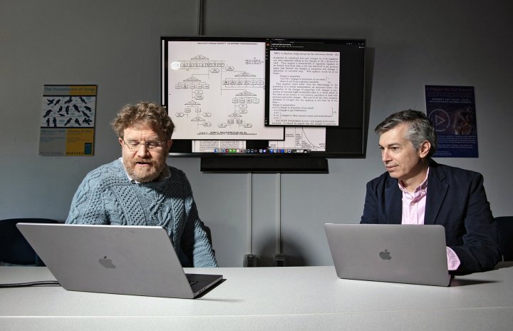 Jones and Wiggins working on laptops