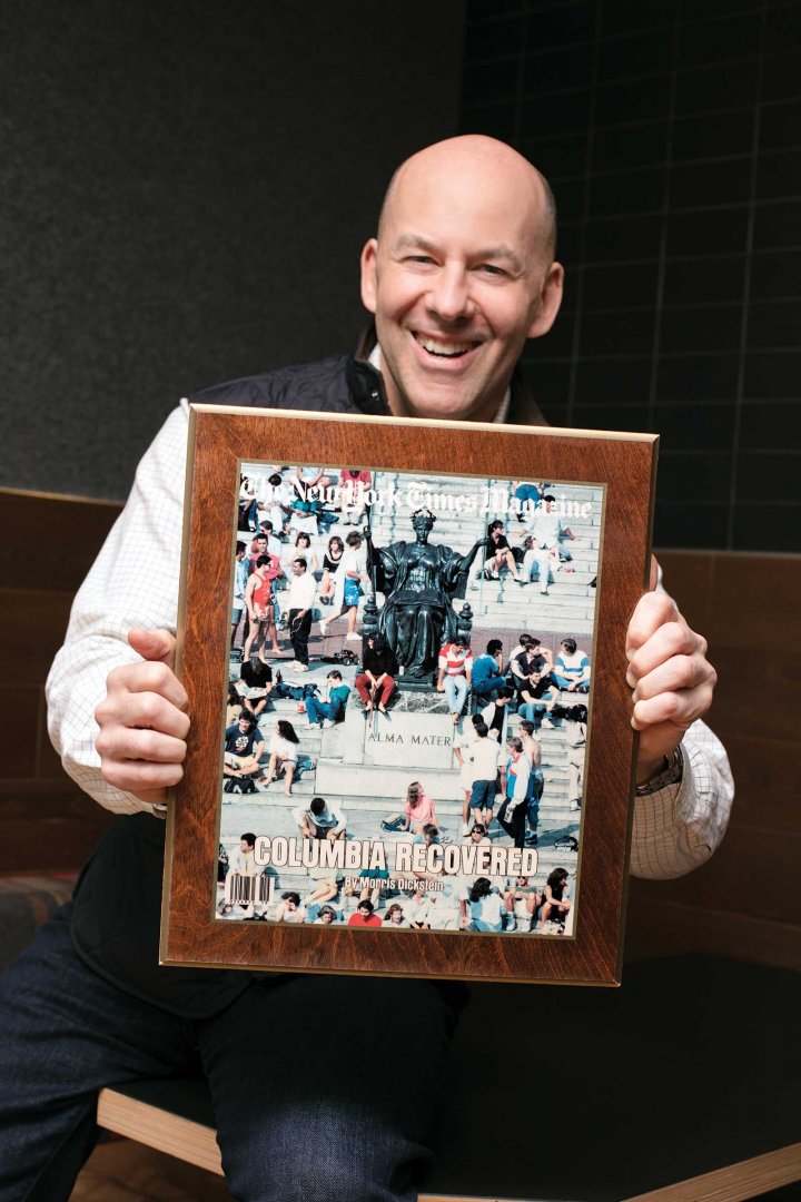 a man holding a framed photo