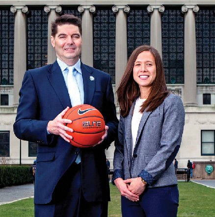 A man holding a basketball and a woman standing next to him