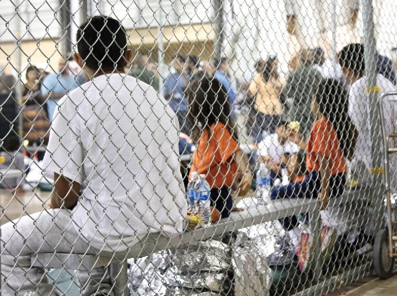 people seen through a chain-link fence