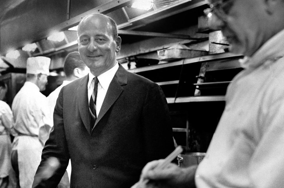 Vincent Sardi wearing a jacket and tie in the kitchen of his restaurant in 1966.