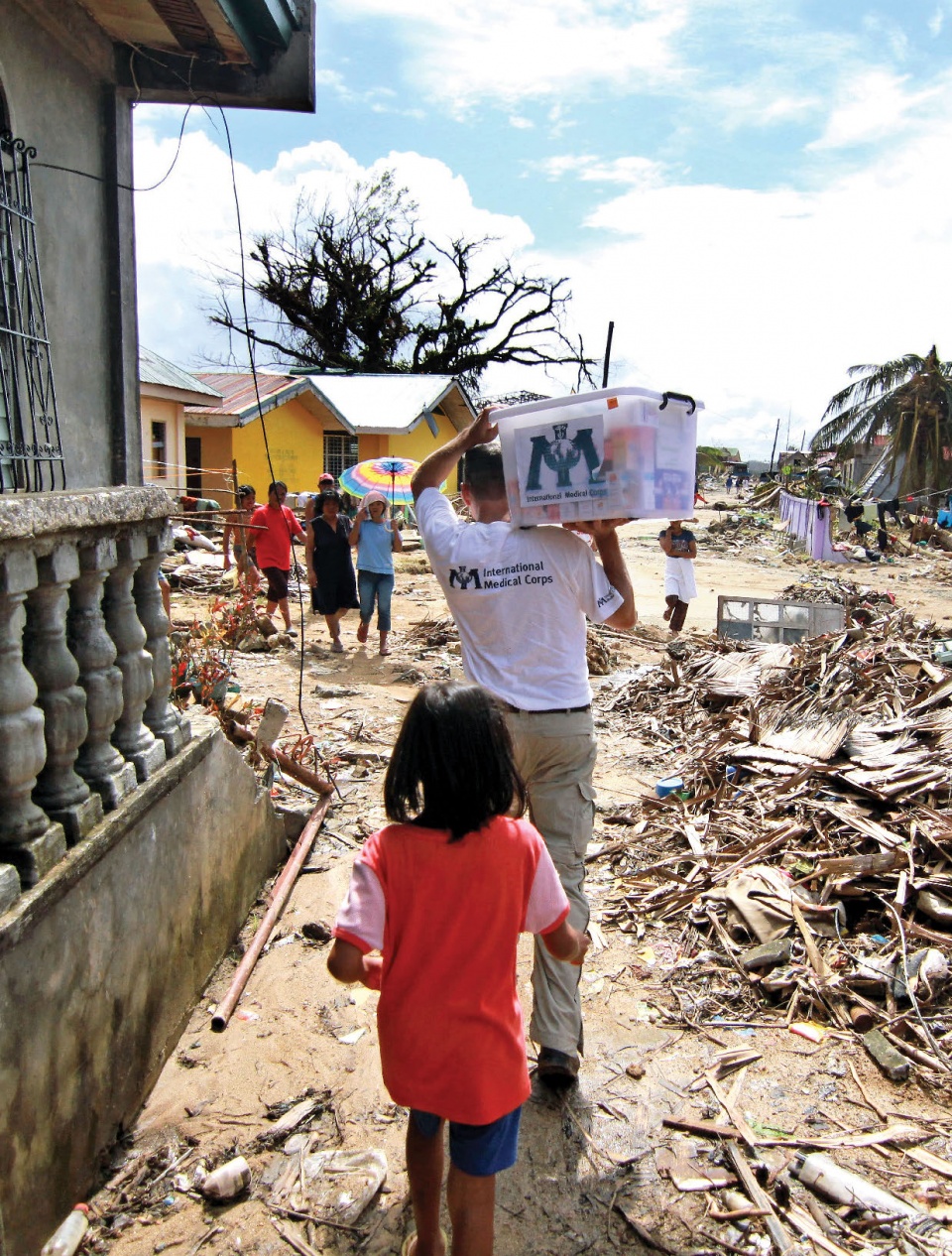 IMC staff carrying supplies