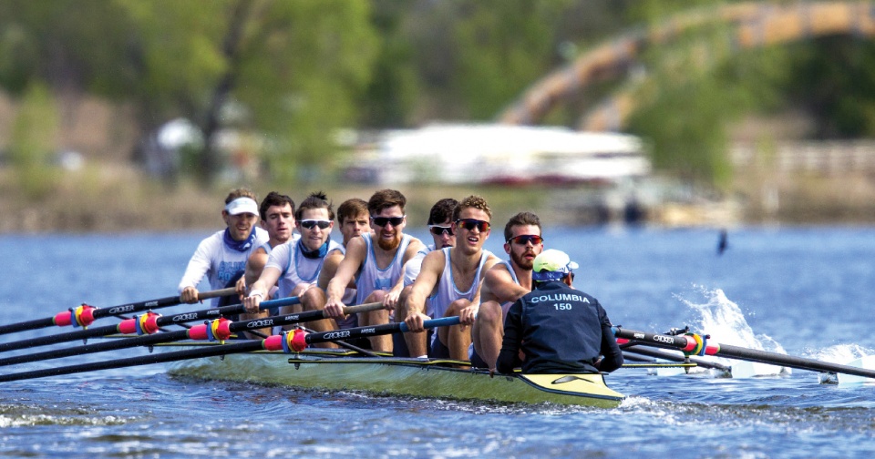 An action shot of men rowing on a river