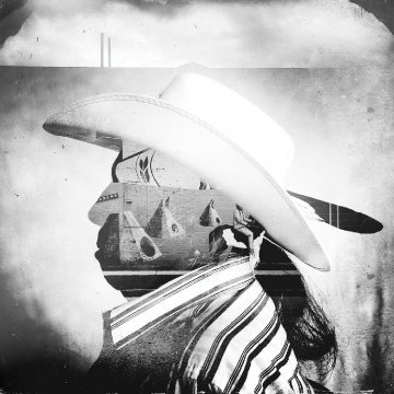 A man wearing a Stetson in profile, overlaid with a landscape