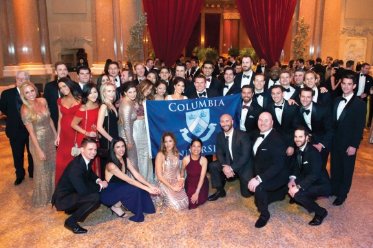 a group of people with a Columbia banner