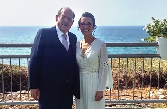 two people in front of the shoreline